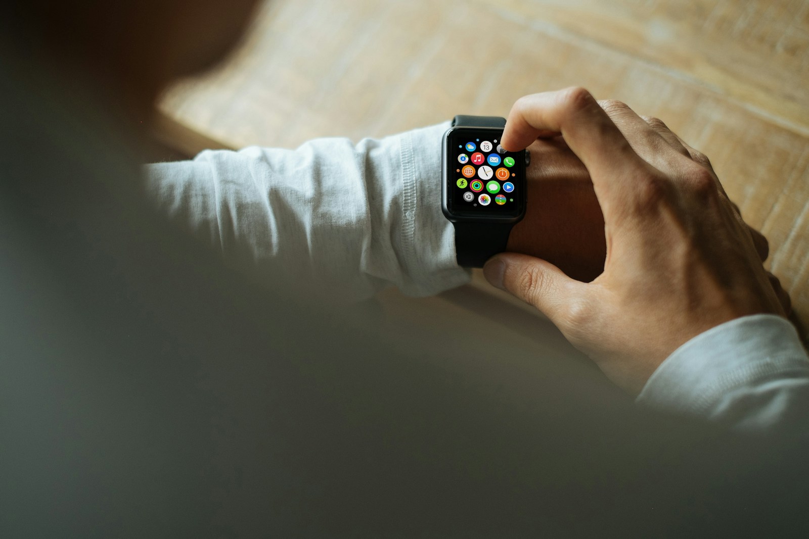 Person holding an Apple Watch with a black sport band