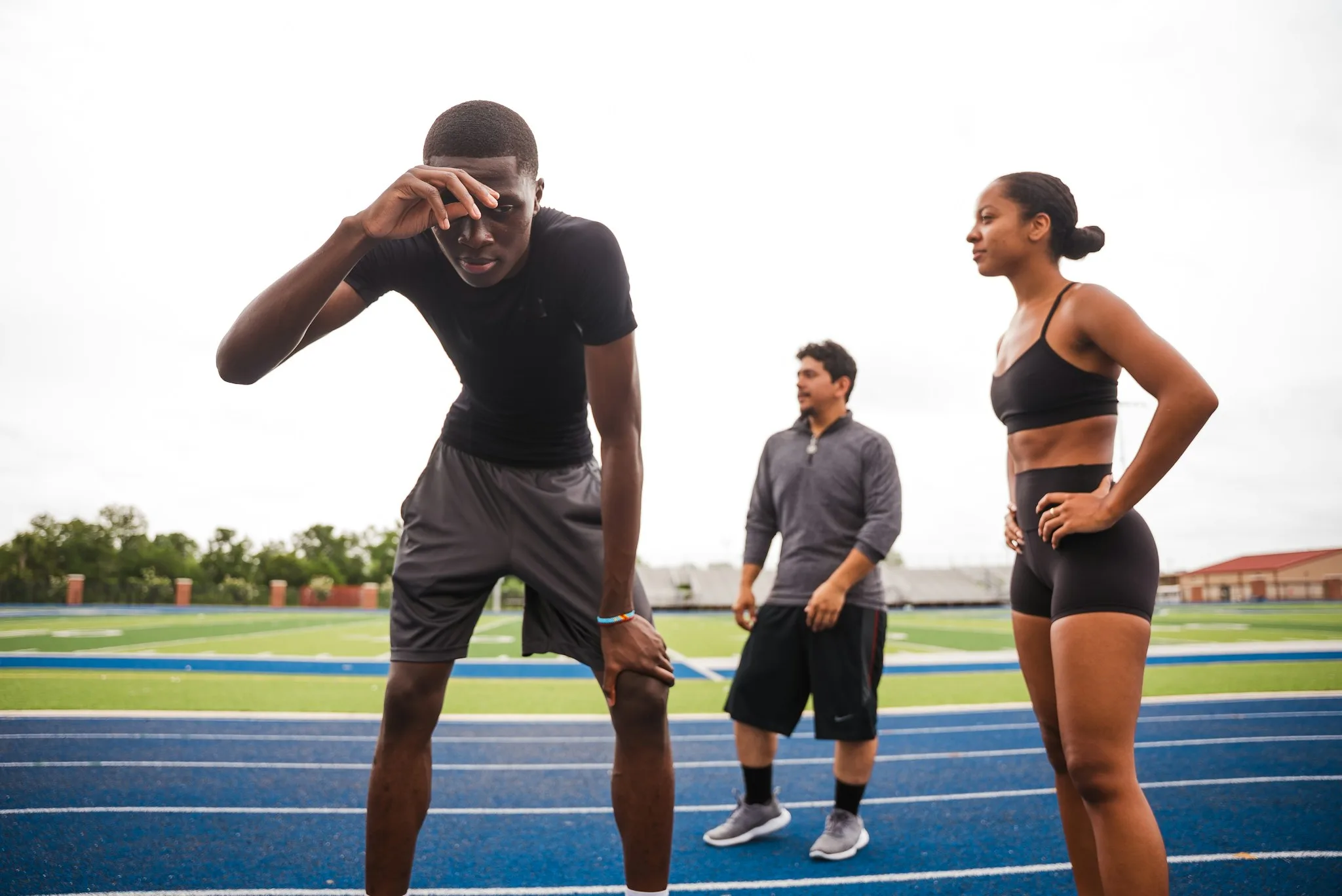 Athlete resting on a track after training with a watch